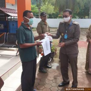 Bupati Hendrajoni, menyerahkan bantuan kepada penerima BLT Provinsi. Foto Humas Pessel